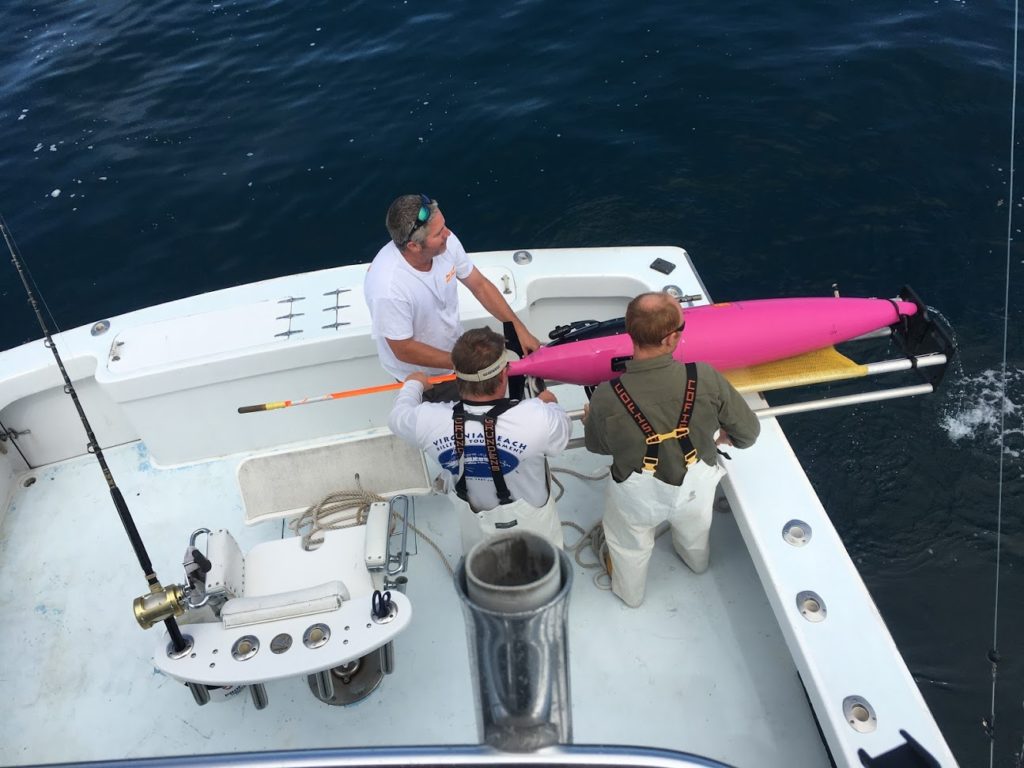 Team preparing a Seaglider on the back of a boat